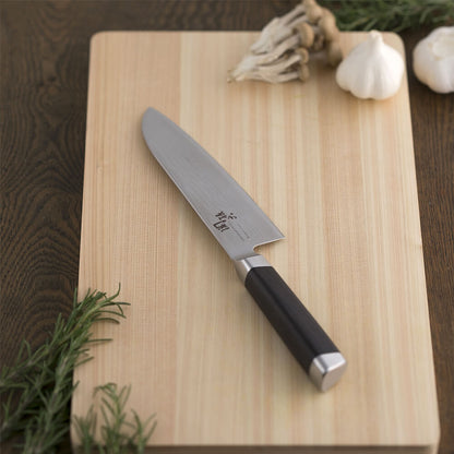 KAI Sekimagoroku Damascus Stainless Steel Santoku Kitchen Knife on wooden chopping board with ingredients