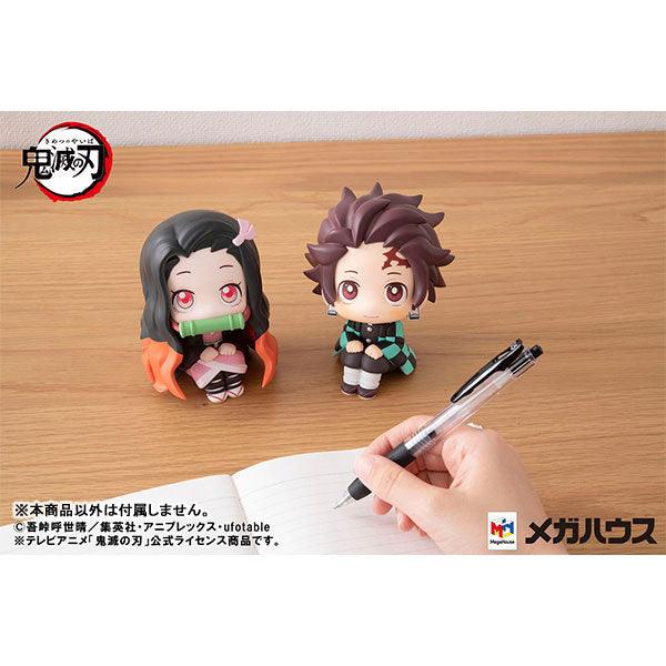 Lookup series Anime Figure Demon Slayer Nezuko Kamado and Tanjiro Kamado sitting together in front of someone writing on notebook